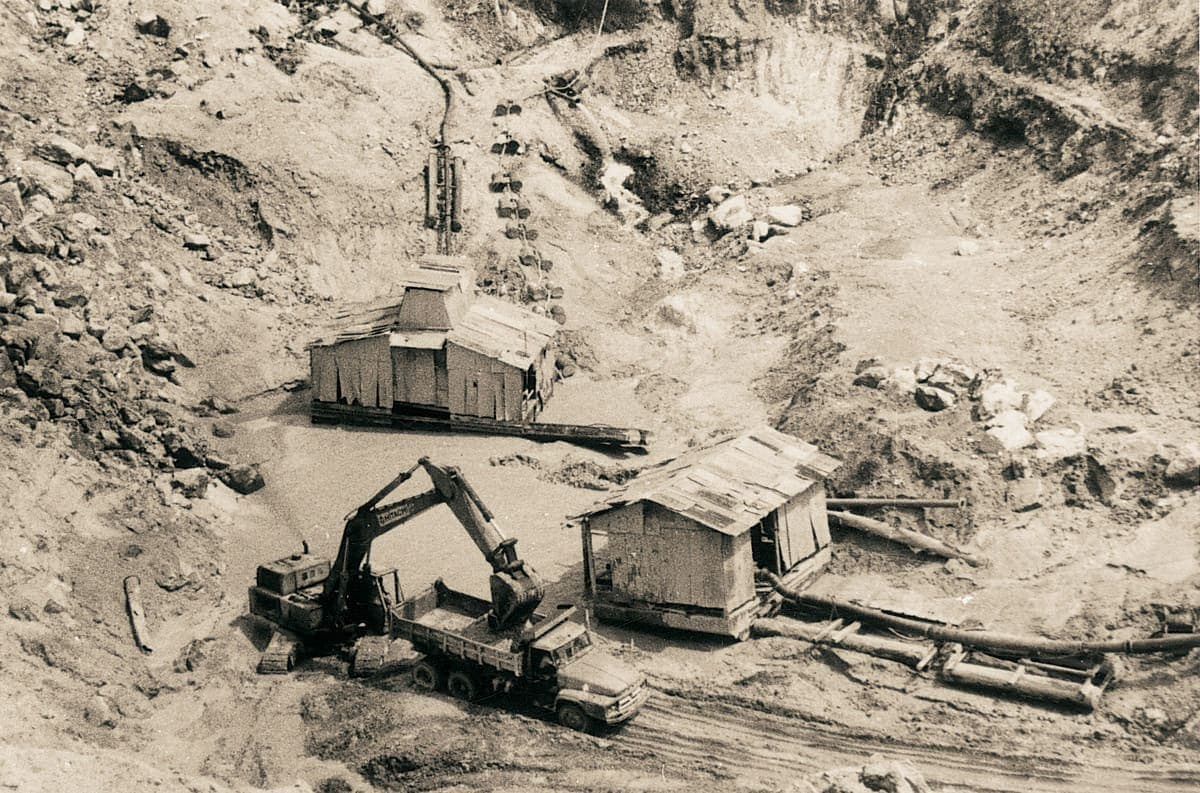 Archival photograph of open-cast tin mining excavation at the site before its transformation