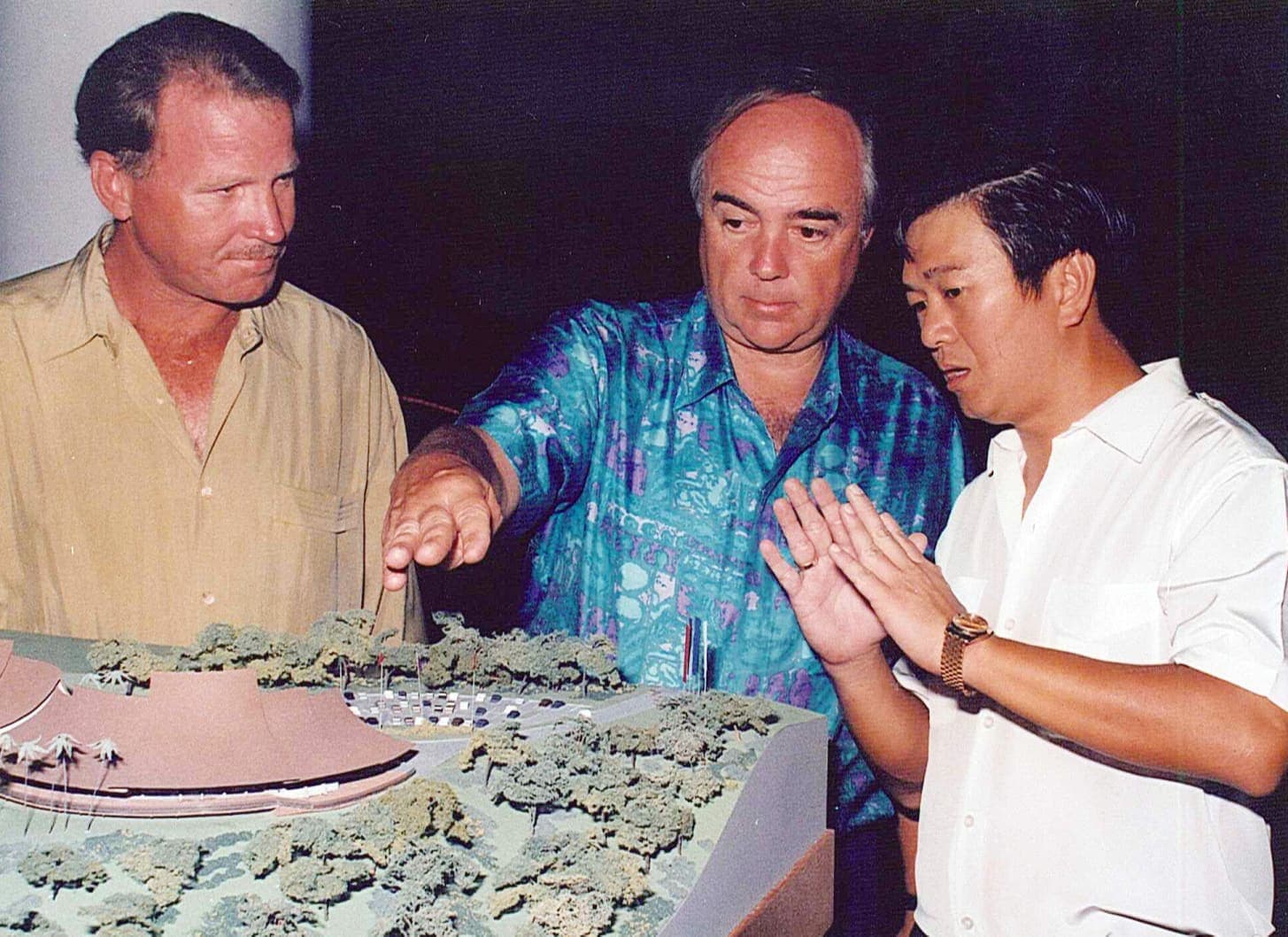 Club founders and architects reviewing a scale model of the planned resort, before construction