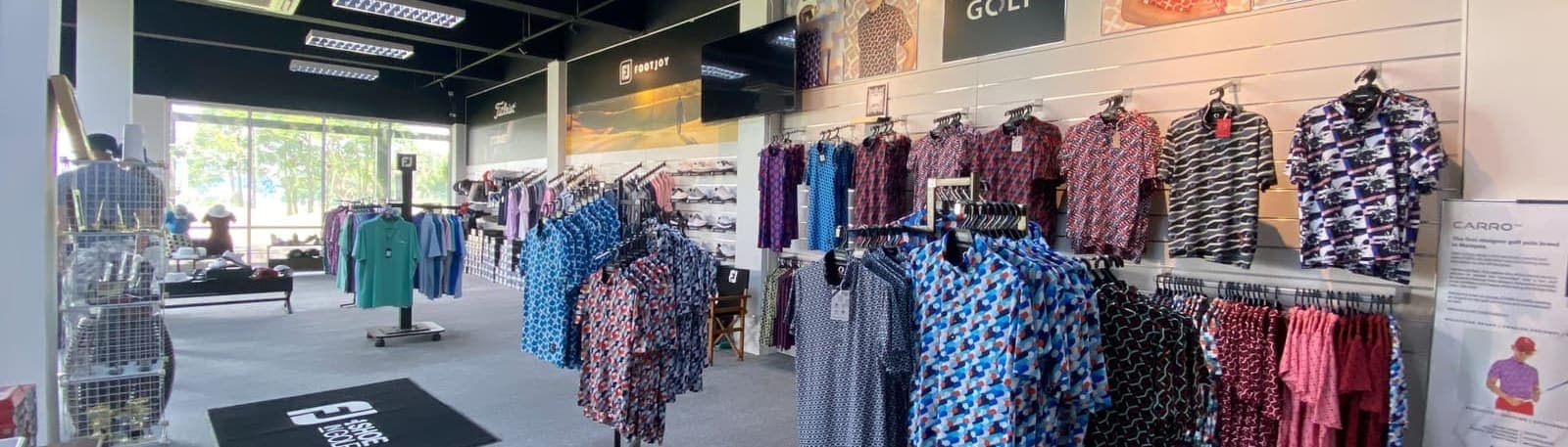 Golf apparel displayed on racks inside the pro shop