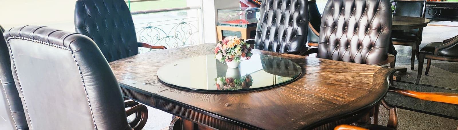 A private dining table with leather chairs, adjoining a games table