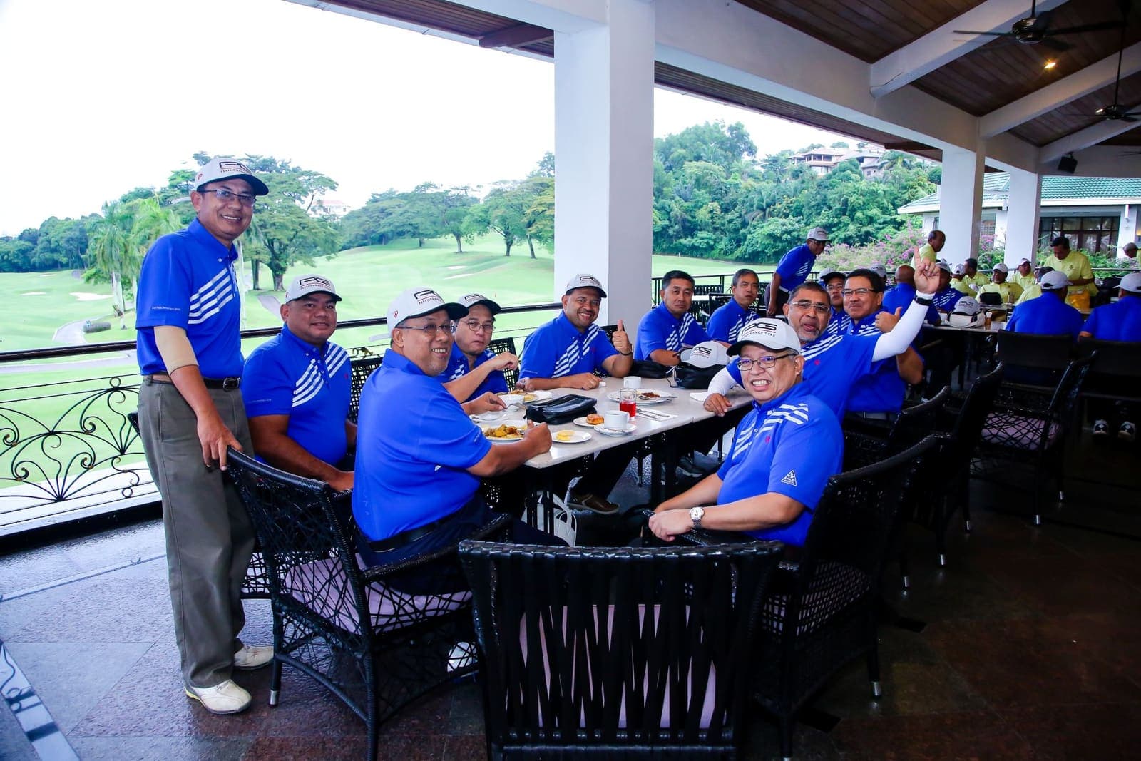 Golfers gathered on the clubhouse terrace after a corporate golf event