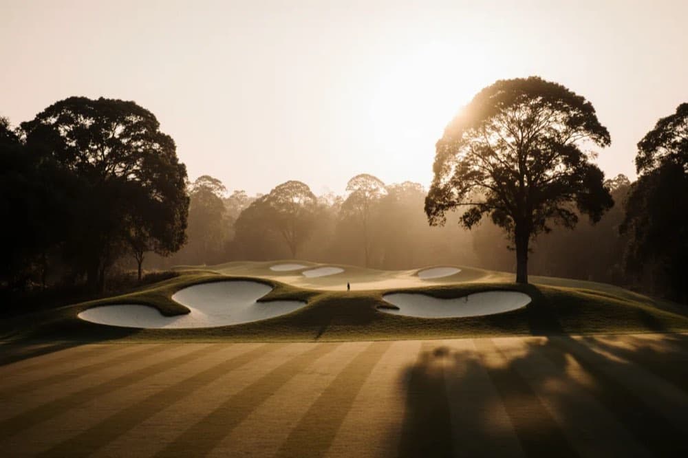 Dogleg fairway with sculpted bunkering in low light
